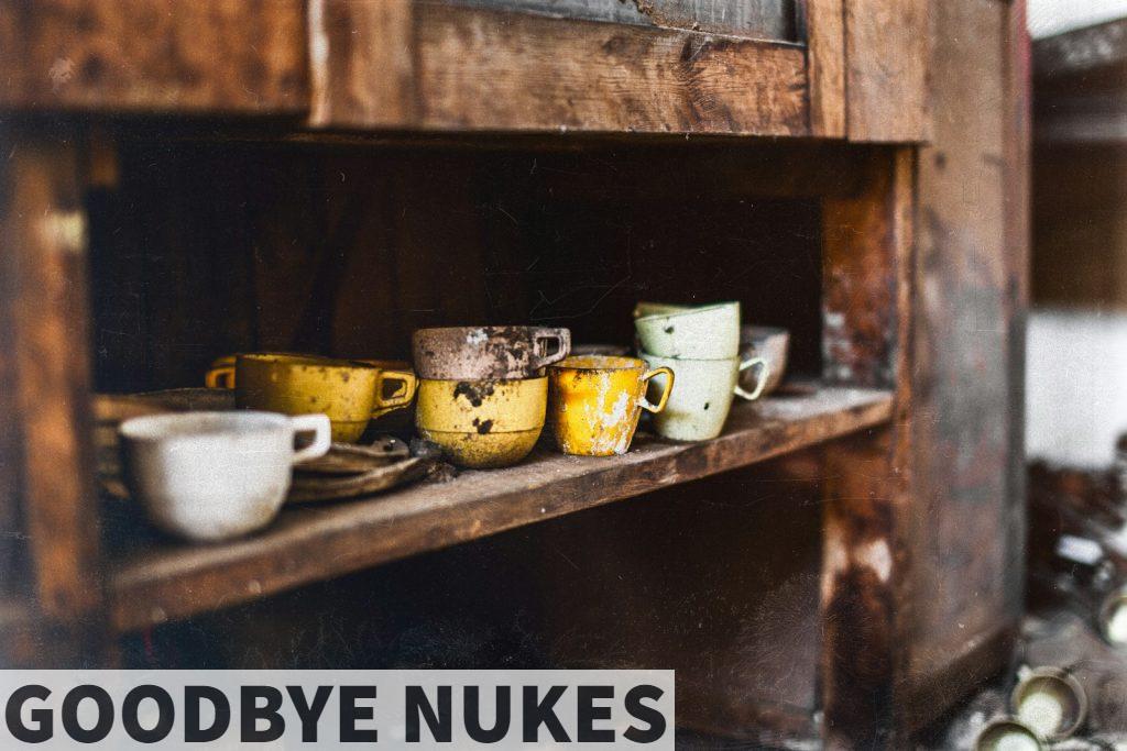 assorted-color teacups on brown wooden shelf