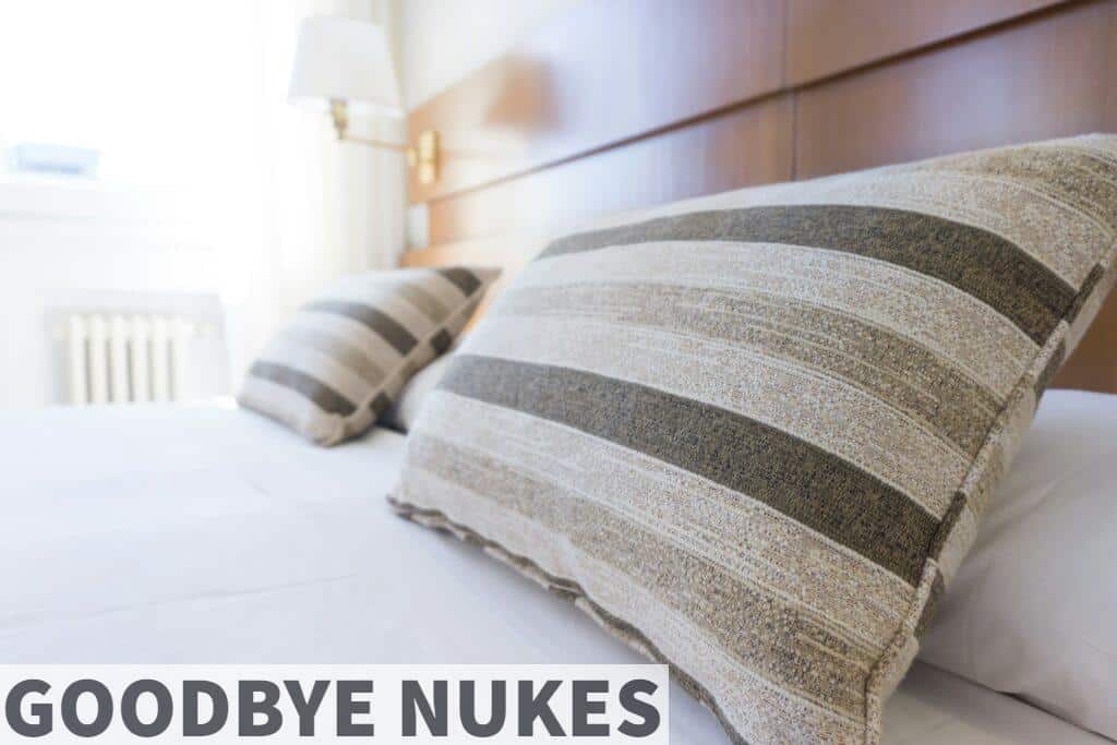 gray and black throw pillow on bed